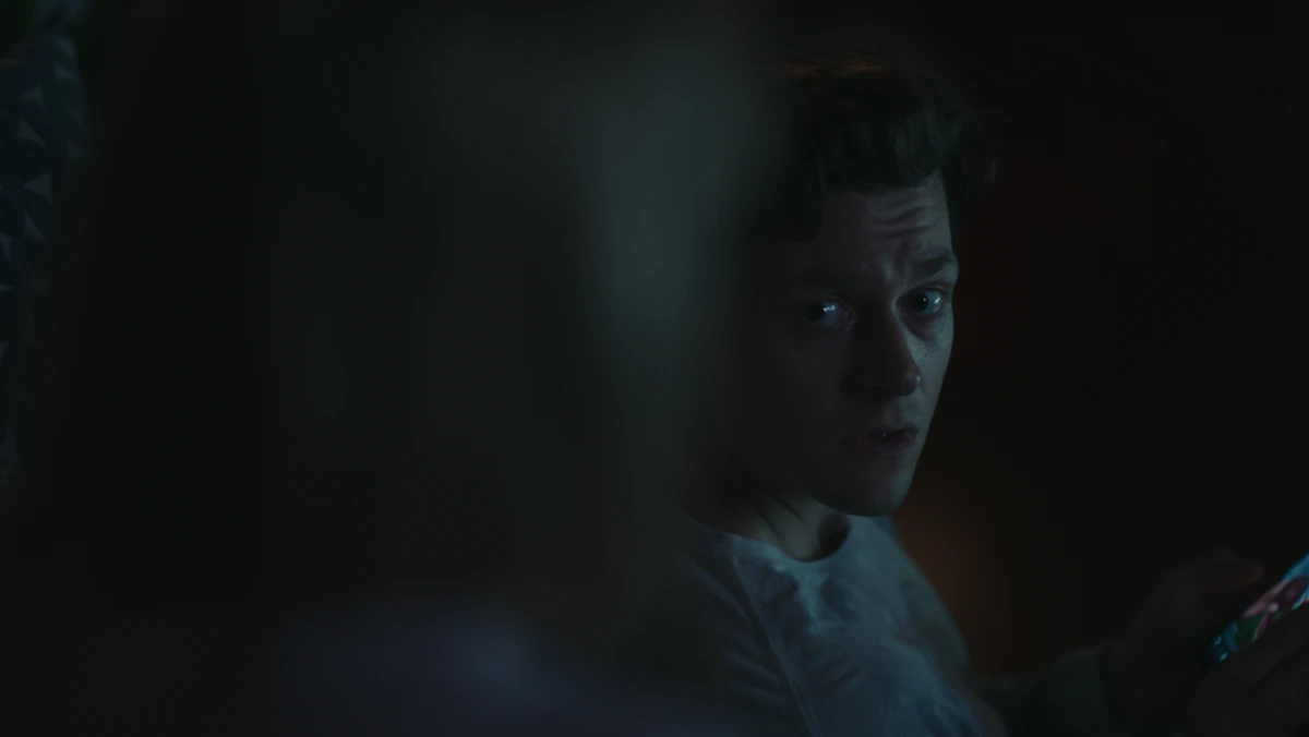 Jared in the dark, lit by his phone.