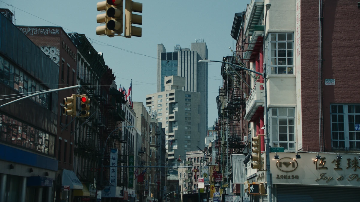 A Chinatown intersection, signals hanging over the street.